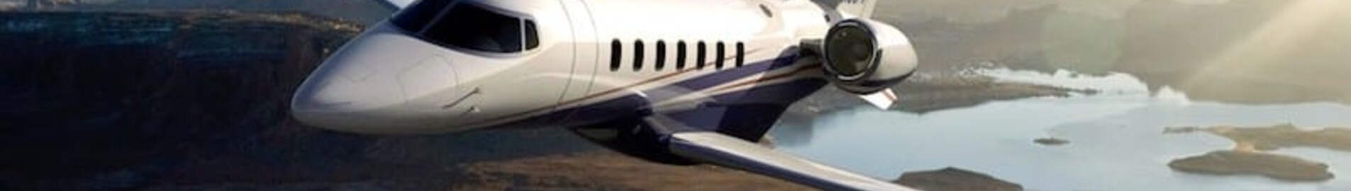 location jet privé - Learjet 85 survolant un paysage naturel