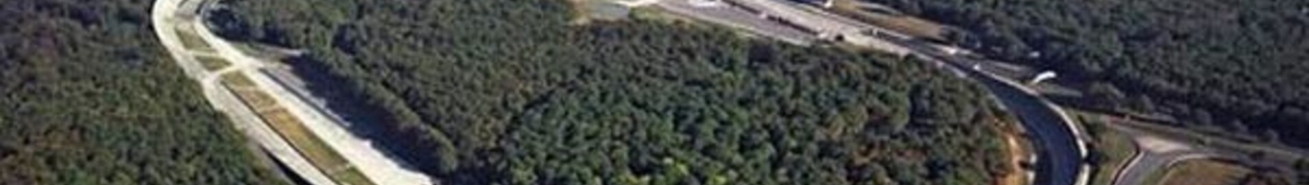Circuit de Montlhéry entouré de forêt et d'habitations.