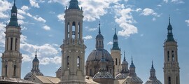 Saragosse : Basilique majestueuse sous un ciel partiellement nuageux.