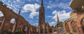 Ruines de la cathédrale de Coventry, ciel bleu, personnes assises.